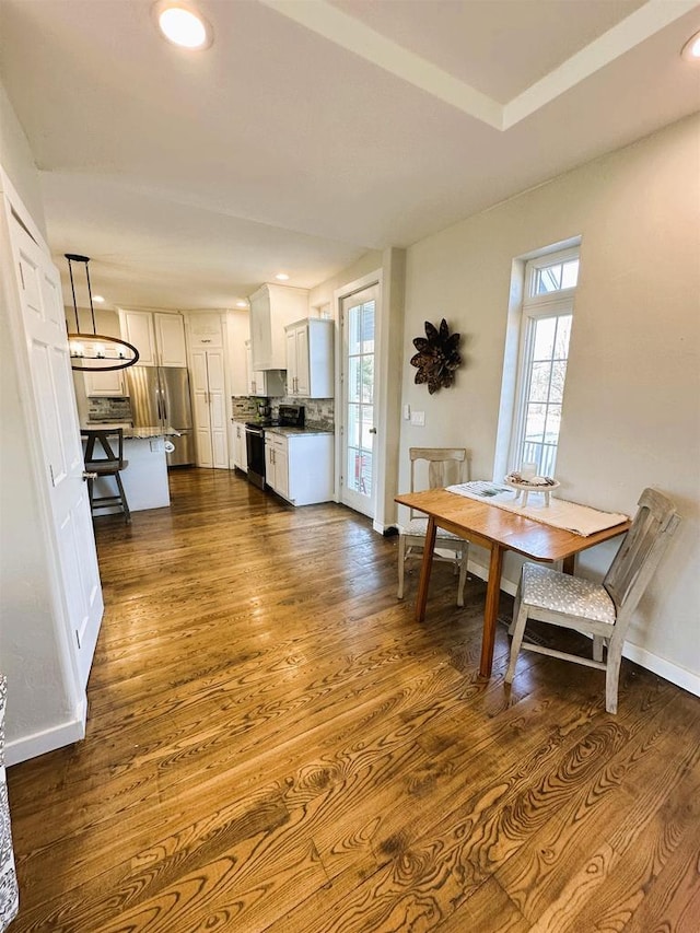 dining space featuring recessed lighting, dark wood-type flooring, and baseboards