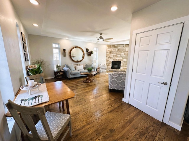 living room featuring baseboards, a fireplace, recessed lighting, dark wood-style flooring, and ceiling fan