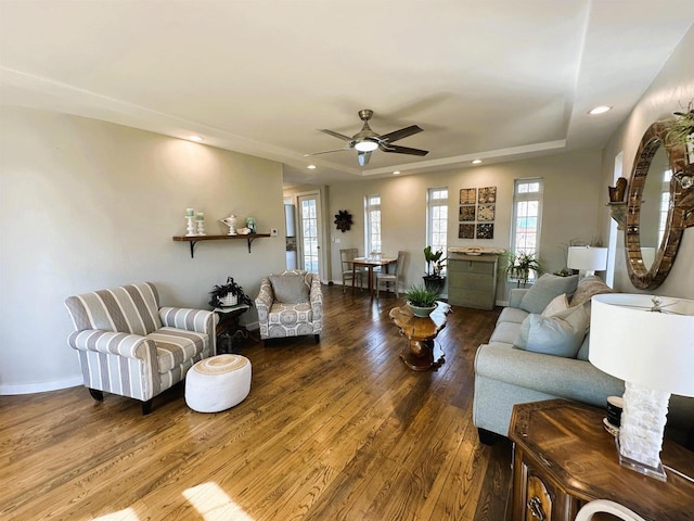 living area with a ceiling fan, recessed lighting, wood finished floors, and baseboards