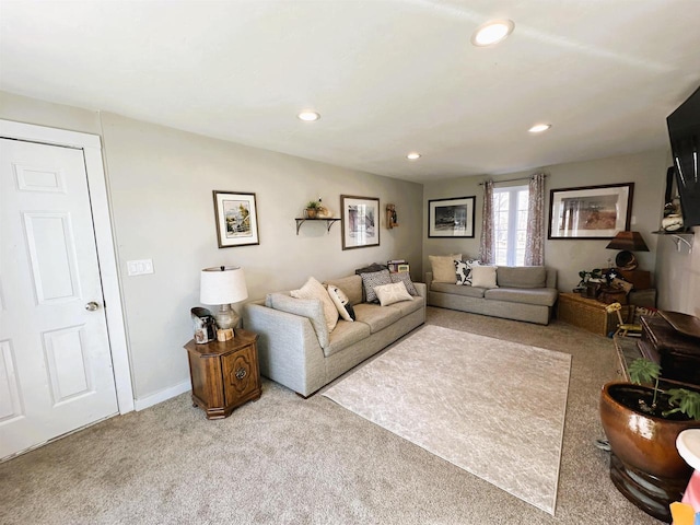 carpeted living area featuring recessed lighting and baseboards