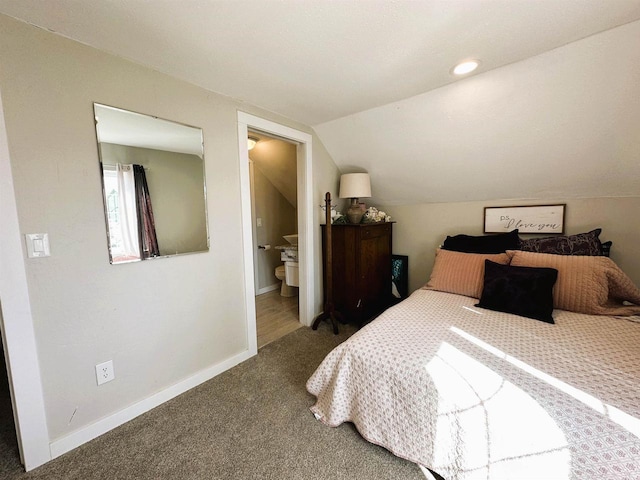 bedroom with carpet flooring, connected bathroom, baseboards, and vaulted ceiling