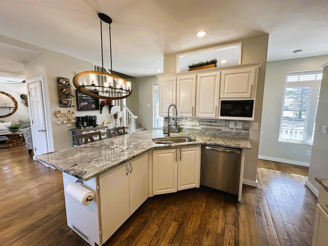 kitchen with backsplash, dark wood-type flooring, black microwave, stainless steel dishwasher, and a sink