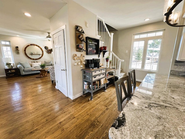 interior space with stairs, plenty of natural light, and wood finished floors