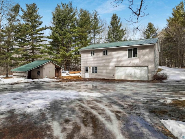 view of property exterior with metal roof and an attached garage