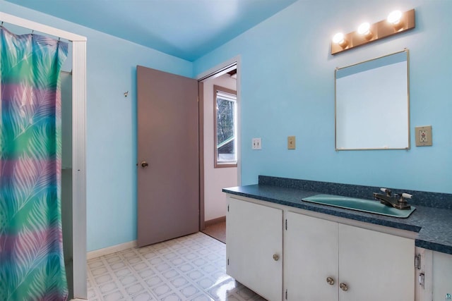 bathroom featuring vanity, tile patterned floors, and baseboards