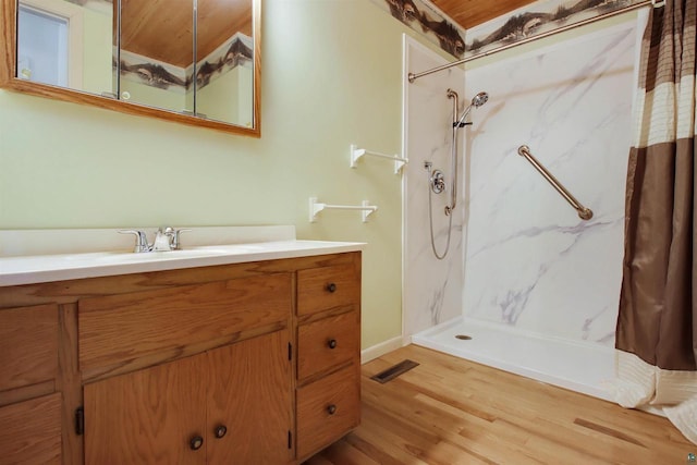 bathroom featuring vanity, visible vents, and a marble finish shower