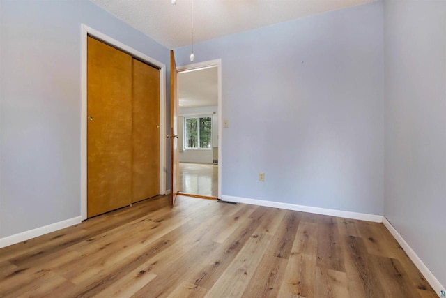 unfurnished room featuring wood finished floors and baseboards