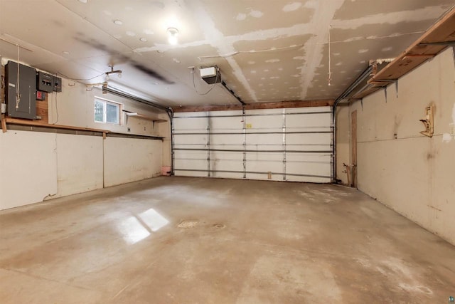 garage featuring electric panel and a garage door opener