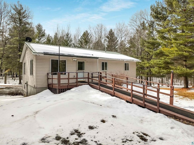 view of front of house with a deck and fence