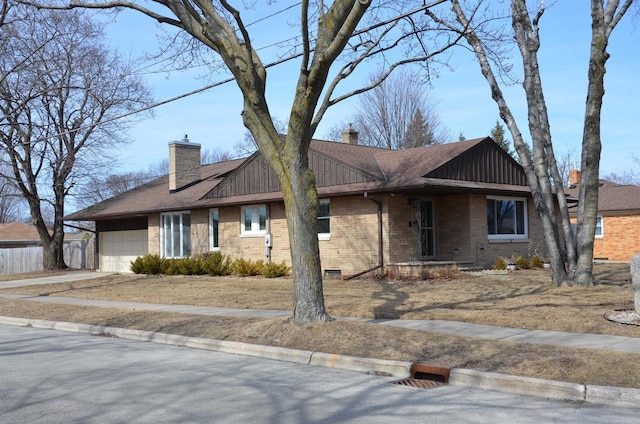 ranch-style house featuring a garage, board and batten siding, driveway, and a chimney