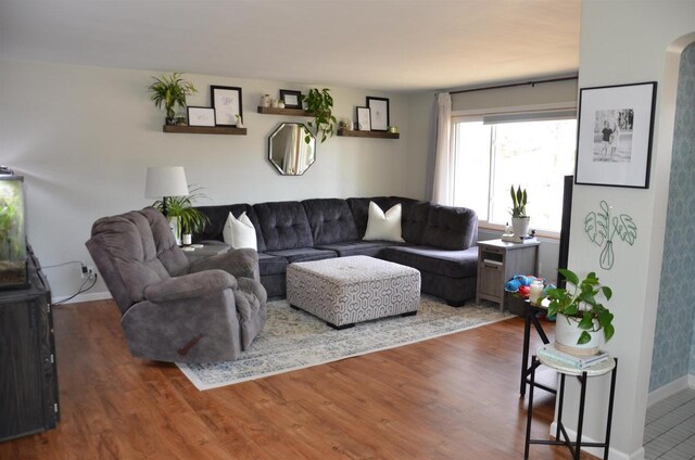 living area featuring baseboards and wood finished floors