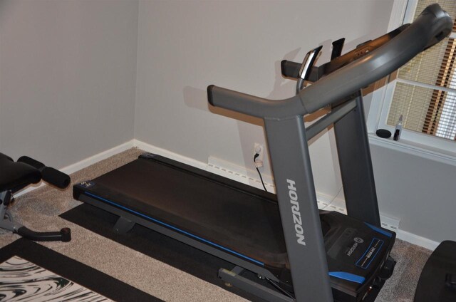 workout room with baseboards and carpet floors