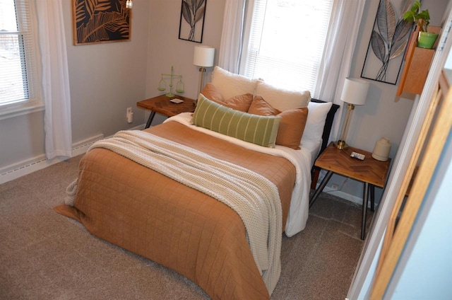 bedroom featuring baseboards and carpet