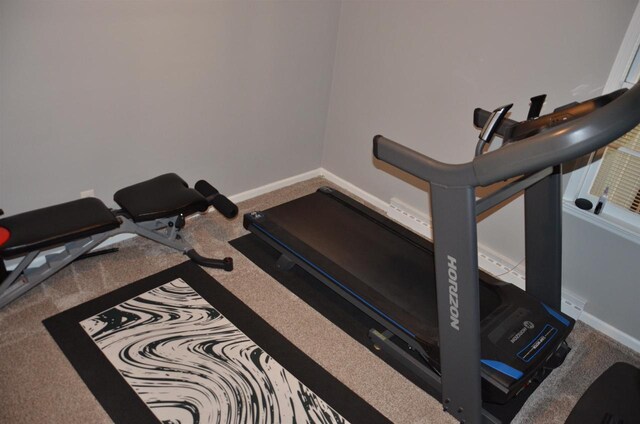 workout room with baseboards and carpet flooring