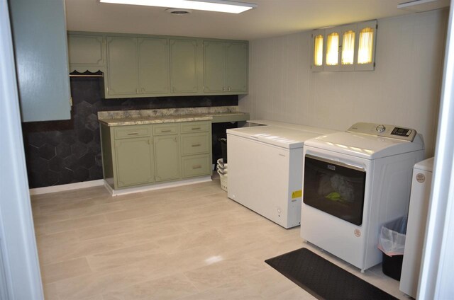 washroom with washer and dryer and cabinet space