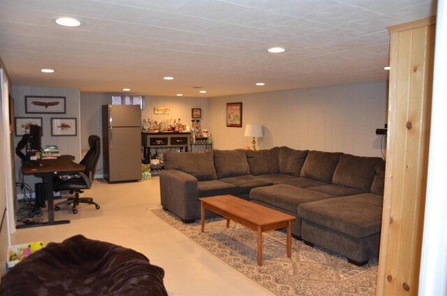 living area with recessed lighting and a bar