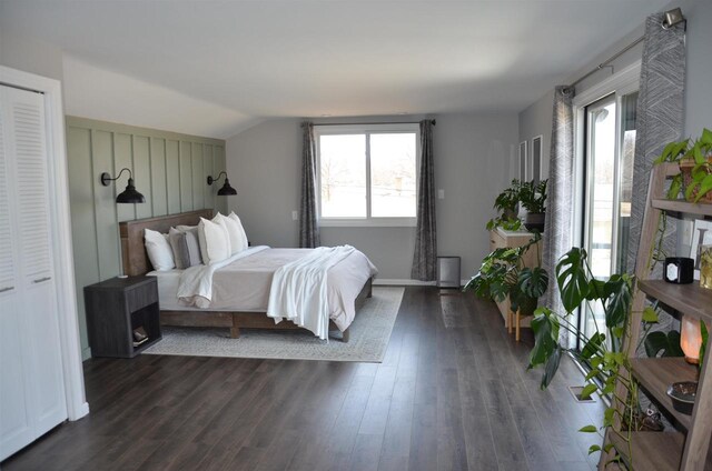 bedroom featuring lofted ceiling and dark wood-style floors