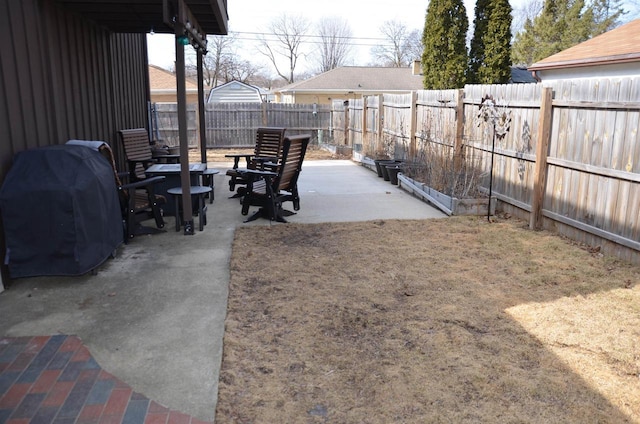 view of patio with area for grilling and a fenced backyard