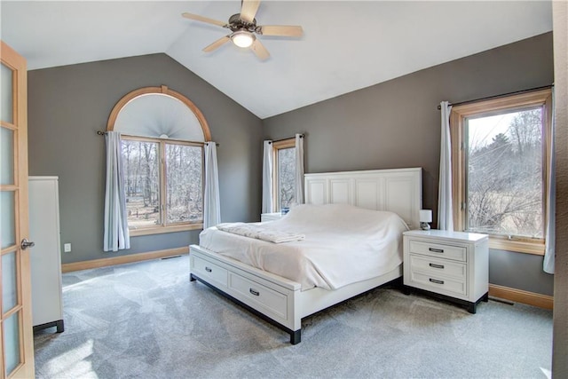 carpeted bedroom featuring ceiling fan, baseboards, and vaulted ceiling