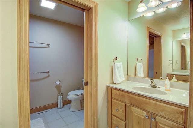 bathroom with visible vents, toilet, tile patterned flooring, baseboards, and vanity