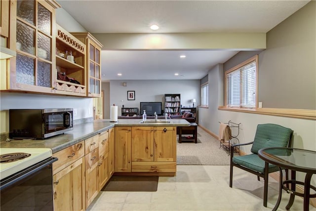 kitchen featuring baseboards, a peninsula, recessed lighting, glass insert cabinets, and open floor plan