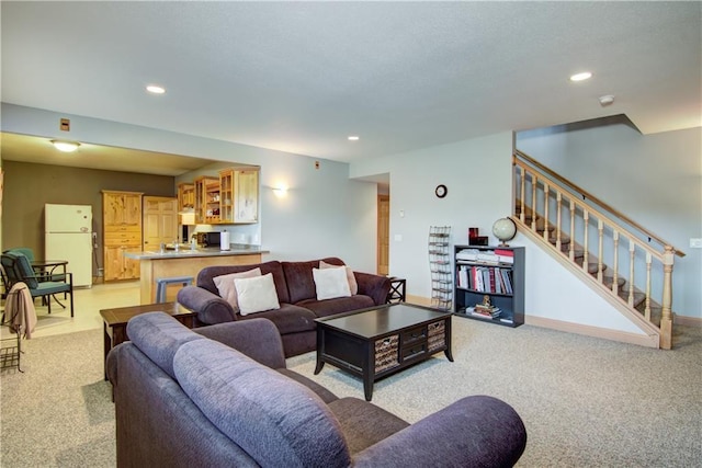 living room with light carpet, stairway, recessed lighting, and baseboards