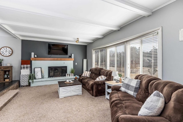 living area with a brick fireplace, beamed ceiling, and carpet flooring