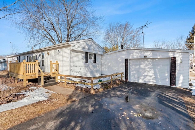 view of front of property featuring aphalt driveway and a deck