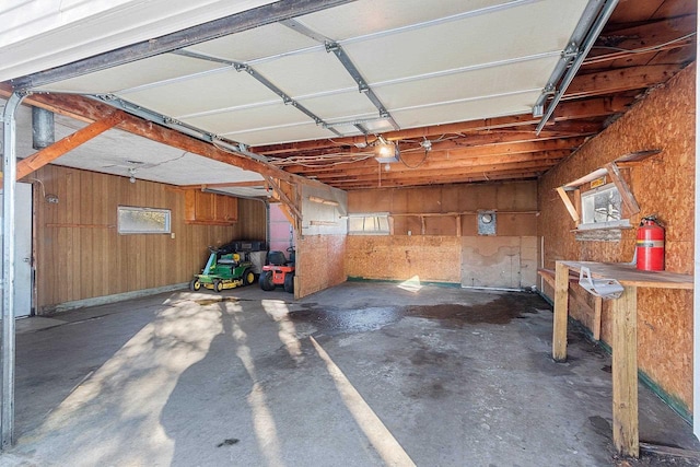 garage featuring wooden walls and a garage door opener