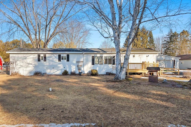 back of house with crawl space, a wooden deck, and a yard