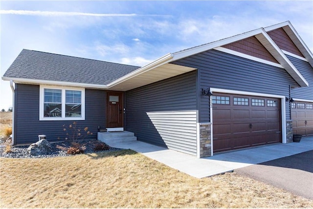 single story home featuring a front yard, roof with shingles, driveway, stone siding, and an attached garage