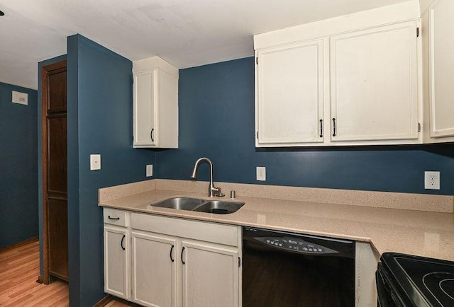 kitchen with dishwasher, white cabinetry, light countertops, and a sink