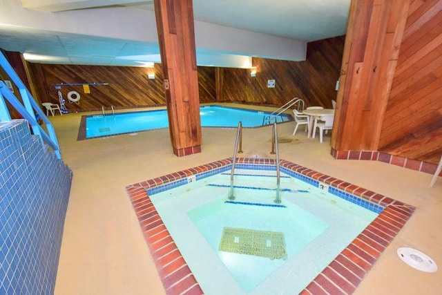 view of pool with an indoor hot tub