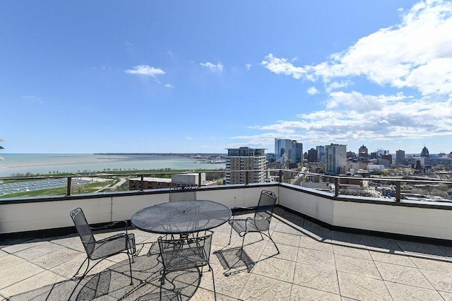 balcony with a water view and a city view