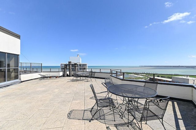 view of patio featuring outdoor dining area and a water view