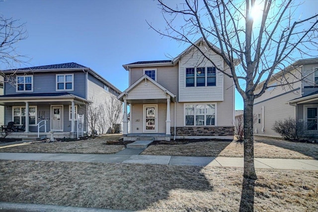 view of front of property with stone siding and covered porch