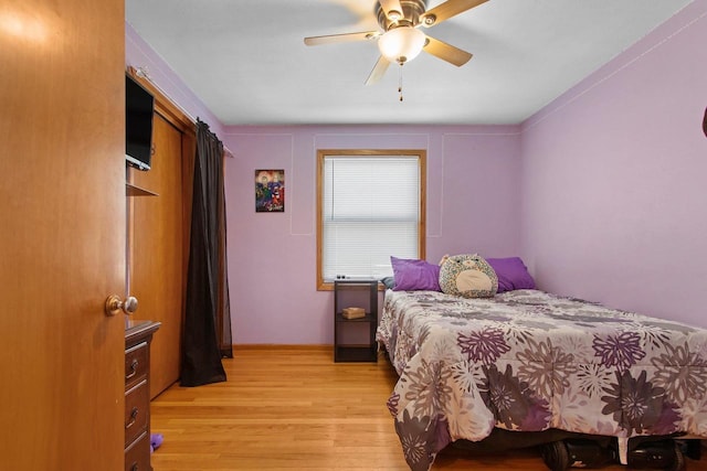 bedroom with a ceiling fan and light wood-type flooring