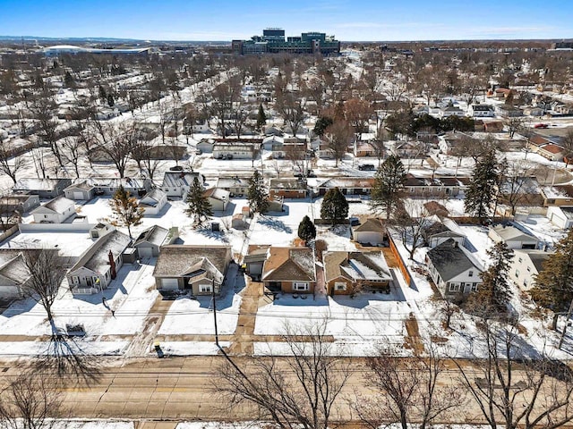 snowy aerial view featuring a residential view