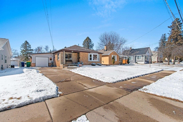 ranch-style house with brick siding, concrete driveway, a chimney, an outbuilding, and an attached garage