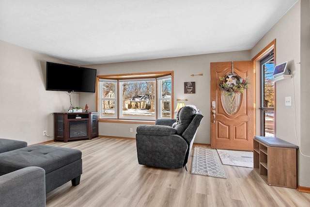 living room featuring light wood-style floors and baseboards