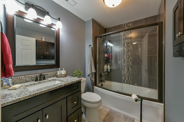 full bathroom with tile patterned floors, visible vents, toilet, bath / shower combo with glass door, and vanity