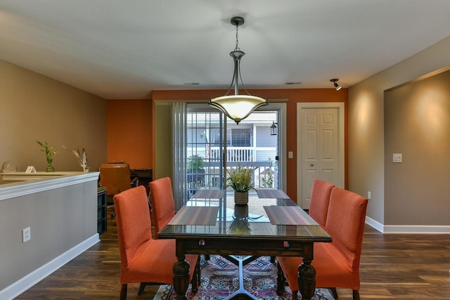 dining area with visible vents, dark wood-type flooring, and baseboards