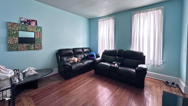 living area featuring hardwood / wood-style flooring and baseboards