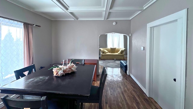 dining room featuring arched walkways, dark wood-style floors, coffered ceiling, and baseboards