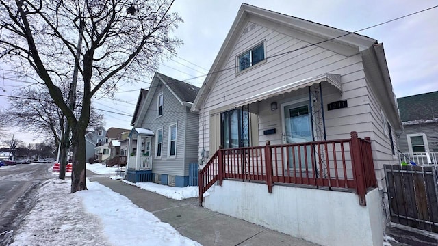 bungalow-style home with fence