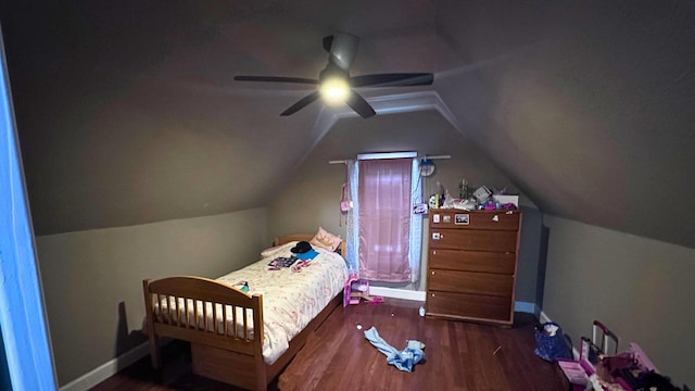 bedroom featuring vaulted ceiling, a ceiling fan, baseboards, and wood finished floors