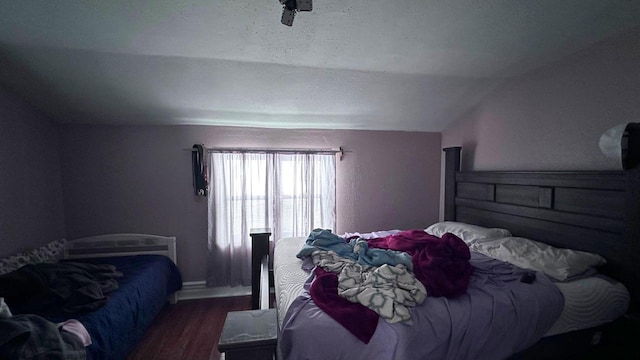 bedroom featuring vaulted ceiling and wood finished floors