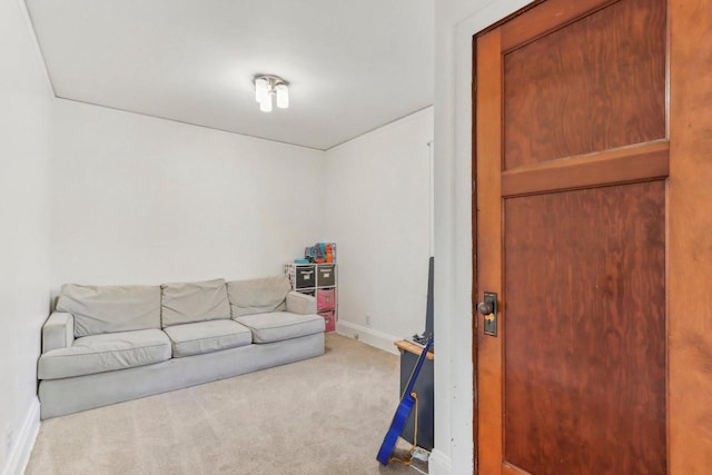 carpeted living room featuring baseboards