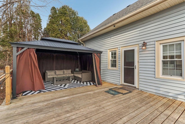 wooden deck with a gazebo and an outdoor living space