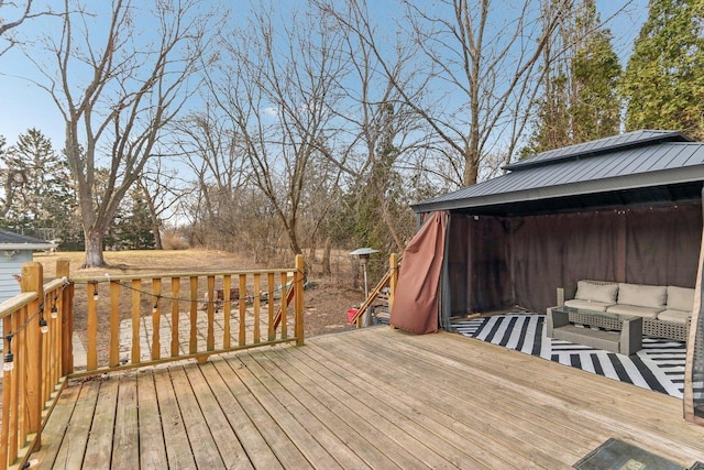 wooden terrace featuring a gazebo and an outdoor hangout area